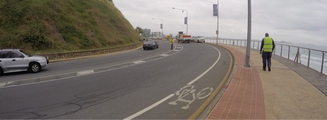 One lane around Kirra Point closes. Yellow safety shirts everywhere.