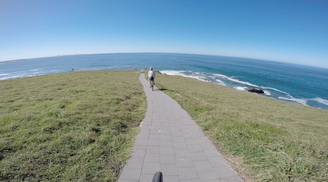 We roll over the headland's crest and around its front. I'm not sure if this is intended as a bike trail but with few people around, we  take the opportunity to enjoy the view!