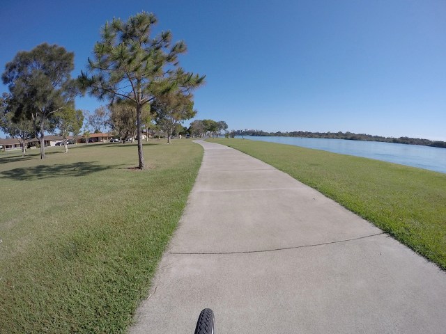 Riding the pathway along the Tweed River under sparkling sunlight under clear skies